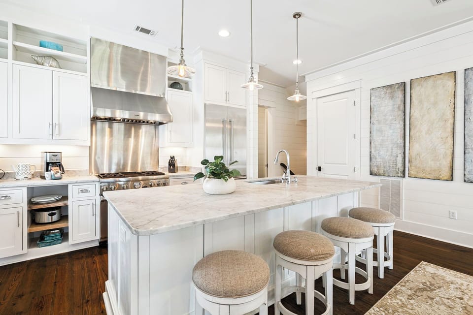 Gather around this bright kitchen island where you'll enjoy preparing meals with gleaming marble countertops, professional-grade appliances, and plenty of elegant storage for all your culinary adventures.