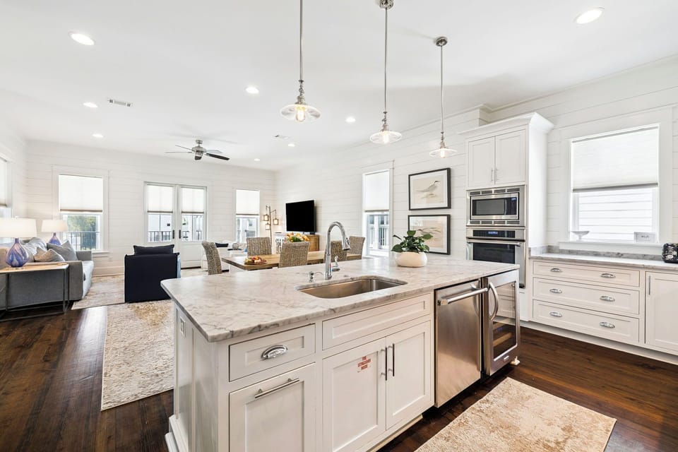 Bright open-concept kitchen flows seamlessly into the living space, with marble island, stainless appliances, and natural light inviting you to cook, gather, and relax together.