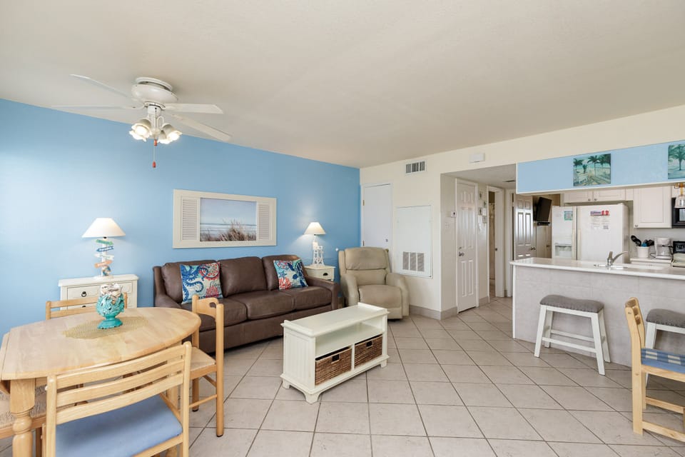 Settle into your bright, beach-themed living space where coastal blues and comfortable furnishings create the perfect vacation retreat.
