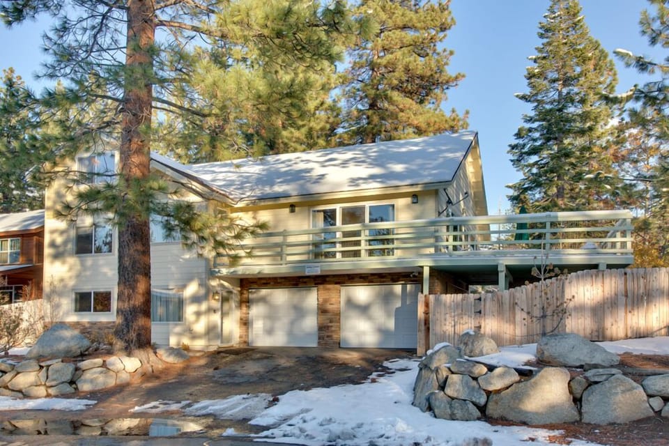 Front view of the home, showing its multi-level design and beautiful natural surroundings.