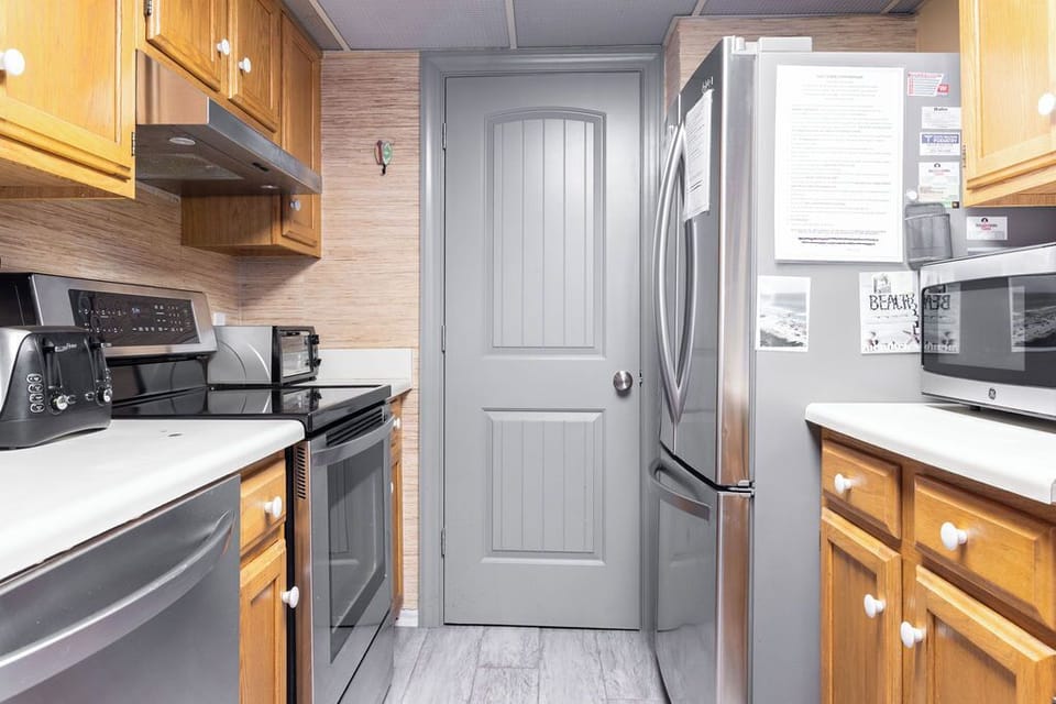 Kitchen - The open kitchen is fully stocked with all items needed for preparing meals during your stay.