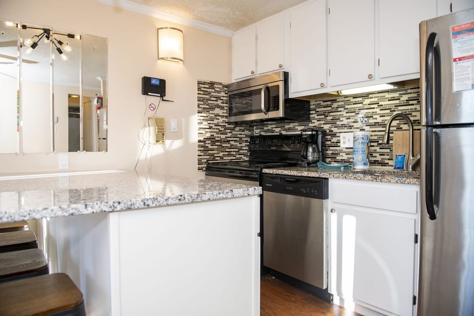 Cook and entertain in style in our fully equipped kitchen featuring stainless steel appliances, perfect for preparing delicious meals during your stay.