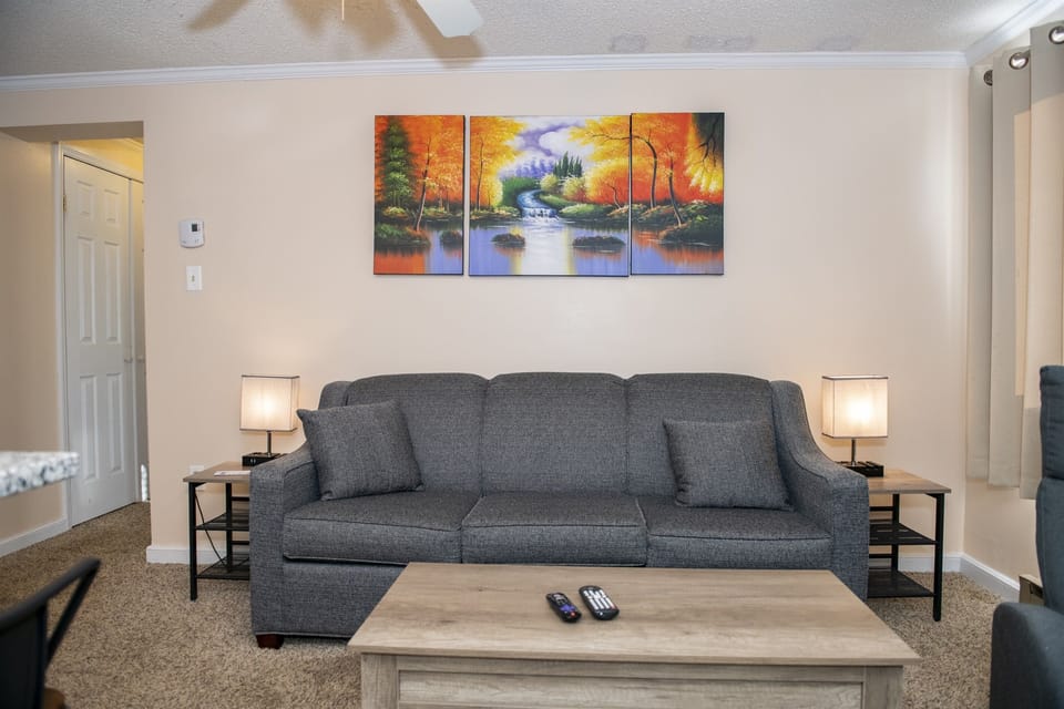 Sleep comfortably in our cozy vacation rental, featuring a queen sleeper sofa in the living area.
