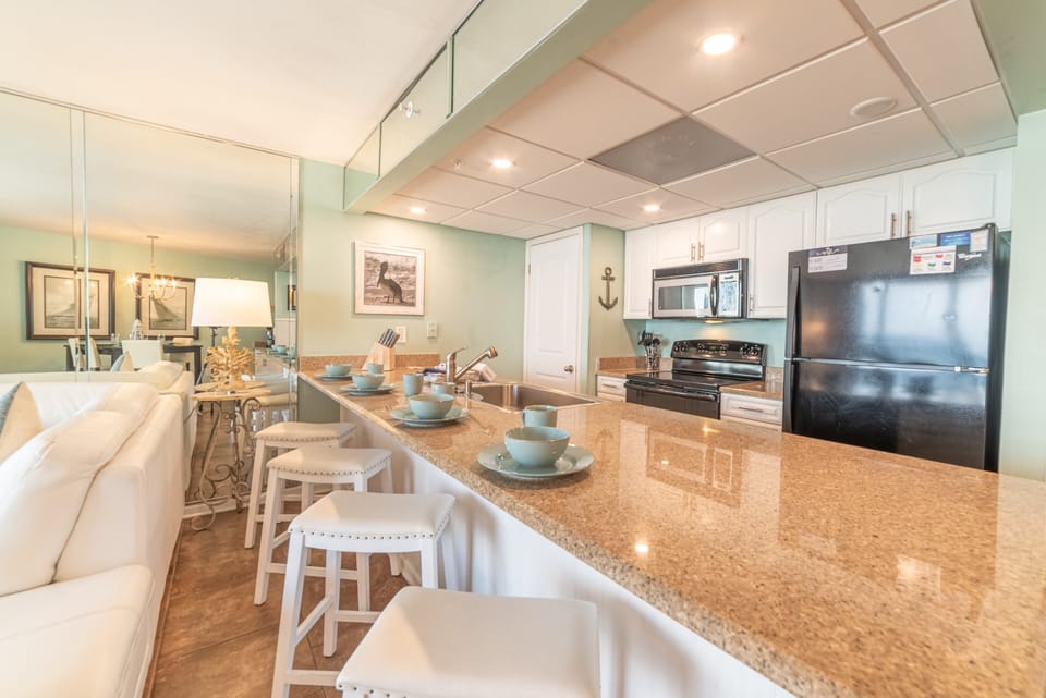 The kitchen offers amazing beach views, high end cabinetry and appliances and granite counter tops