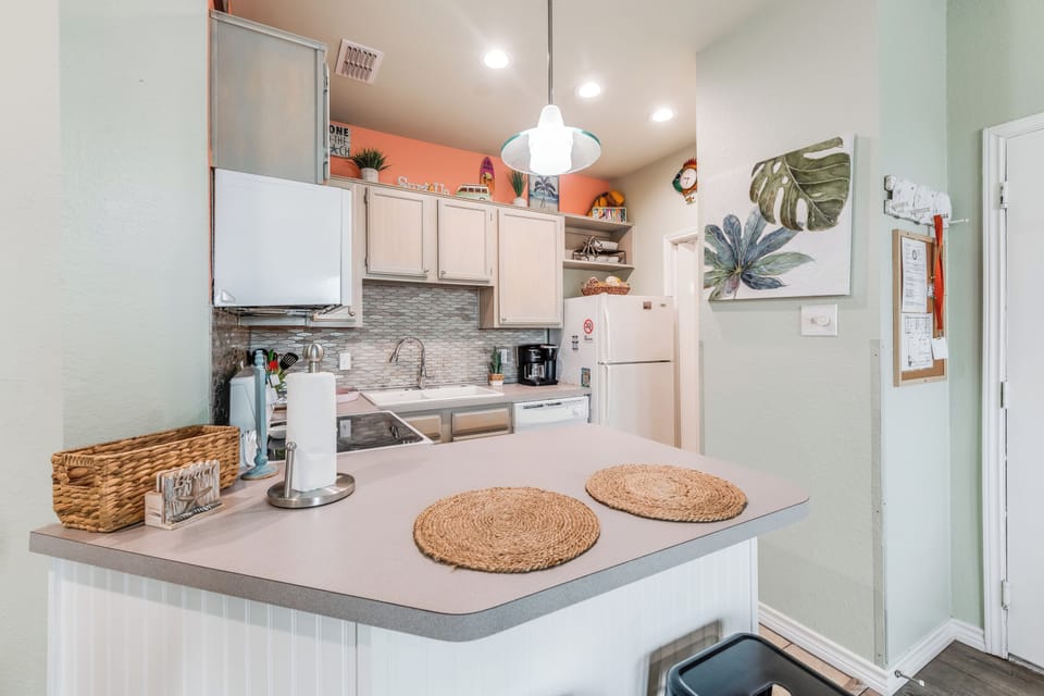 Your fully equipped kitchen awaits with modern appliances and coastal charm, perfect for preparing meals during your stay.