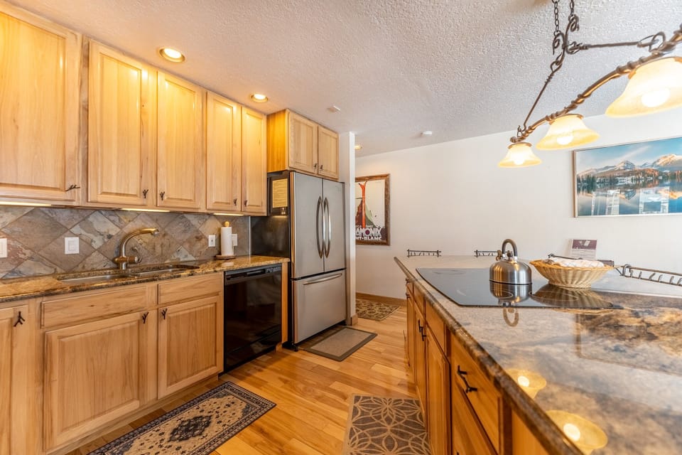 Your gourmet kitchen features granite counters, wood cabinets, and stainless appliances for memorable meals.