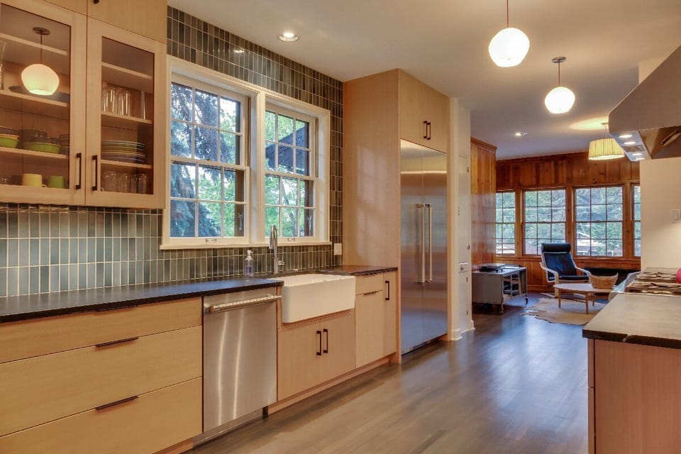 The modern kitchen is complete with a 6 burner Thermador range, farmhouse sink and soapstone counter tops.