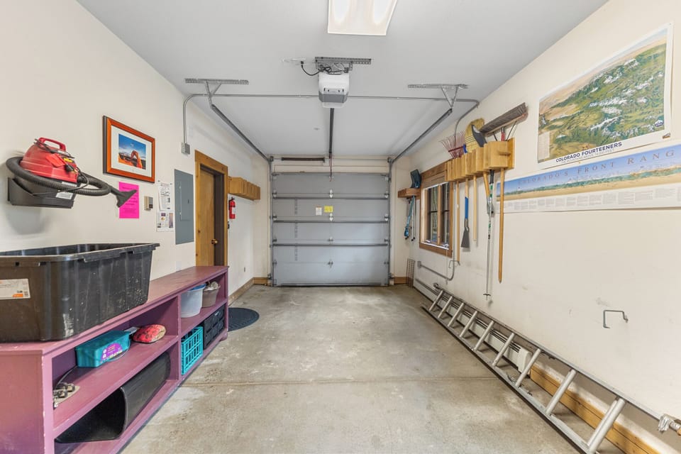Spacious garage with organized storage and workbench provides convenient parking and extra space for your gear and equipment during your stay.