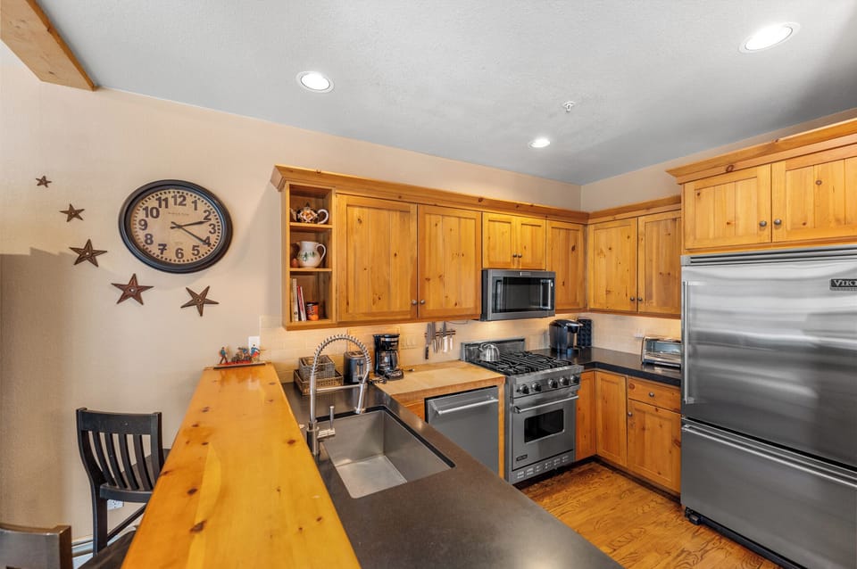 Your fully equipped kitchen features warm wood cabinets, stainless steel appliances, and charming rustic touches perfect for preparing memorable meals.