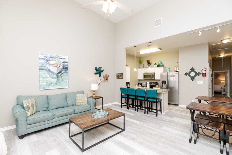 Open-concept living area with high ceilings, flooded with natural light and providing the perfect ambiance for unwinding after a day of adventures