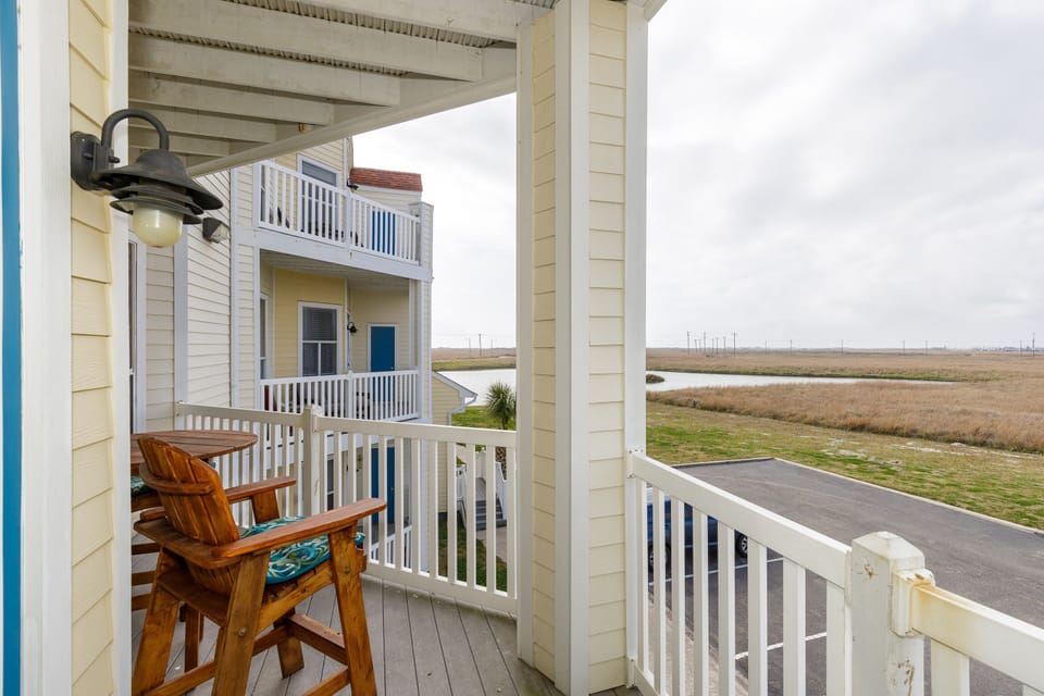 Sip your morning coffee on this peaceful covered balcony overlooking open marshlands and distant coastal views.