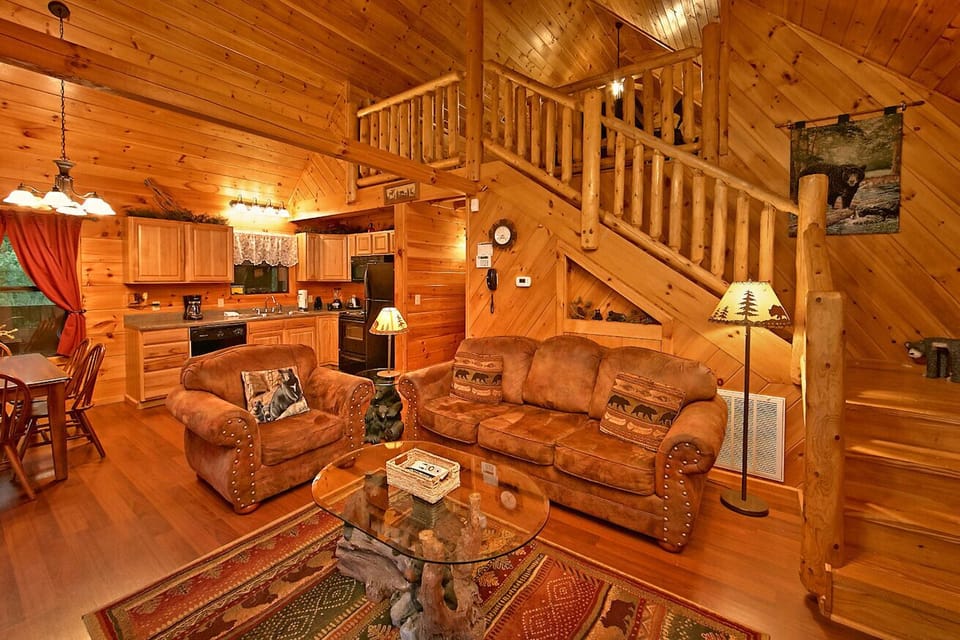Cabin has a huge 2 person shower. Relax on the wooden rocking ch - View of beautiful living room and view of upstairs as well.