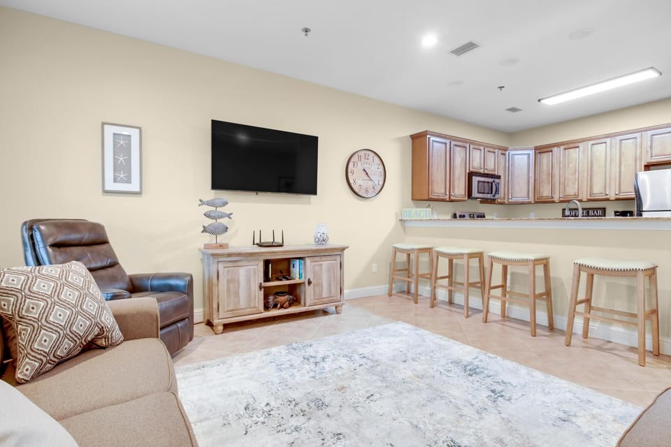 Living Area - The spacious living area offers plenty of seating and a mounted television for enjoying your down time. New furnishings are provided and offer a great space for extra relaxation.