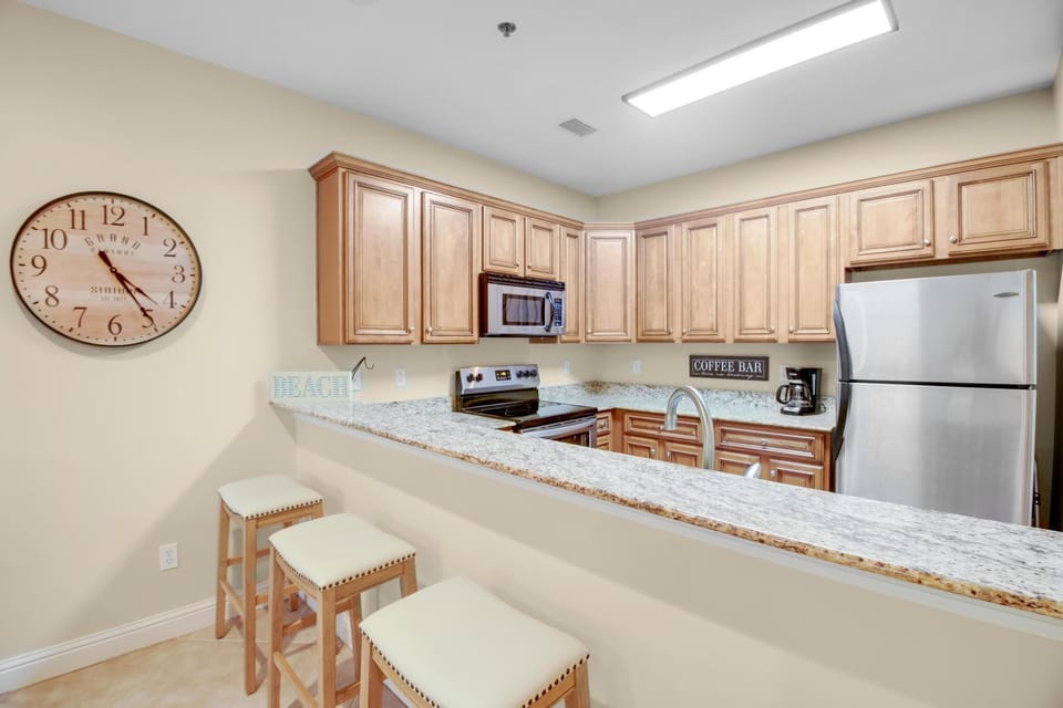 Kitchen - The kitchen features a large, eat-in style bar that is great for serving, but also provides extra places for enjoying your meals. A traditional coffee pot as well as small k-cup style is provided for use during your stay.