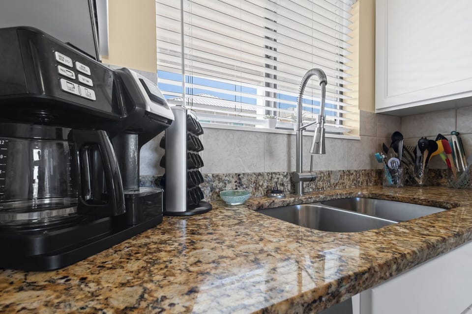 Kitchen - The kitchen features granite countertops, and is fully stocked with all items needed for preparing meals. Enjoy your morning coffee cup by cup or brew an entire pot.