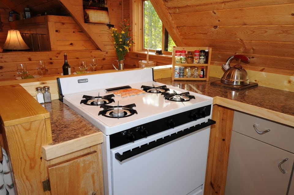 The sunny kitchen gets views of the sunrise over the ridge.