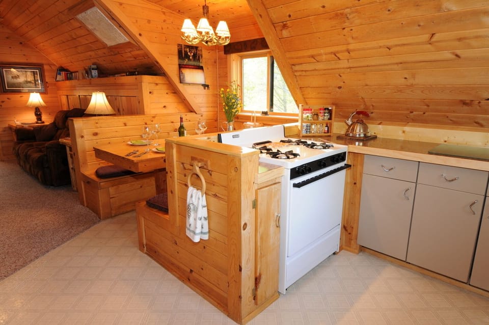 The kitchen and adjoining booth-style dining area.
