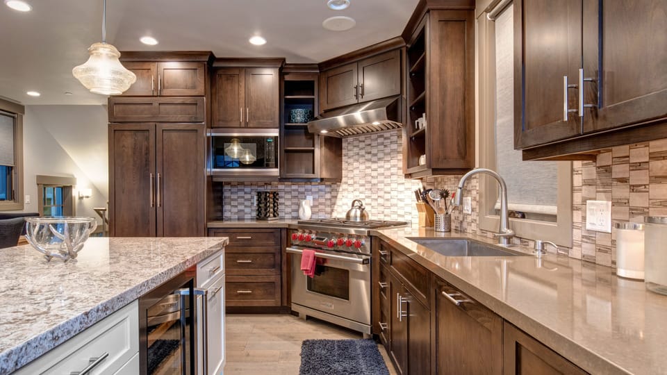 Enjoy cooking in the stylish, fully-equipped kitchen with a large central island, granite countertops, and modern amenities.
