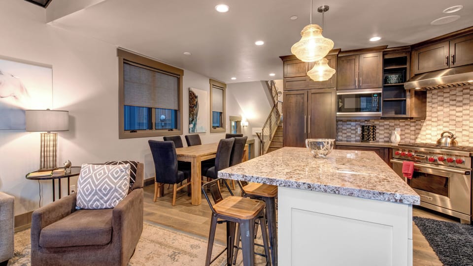 Enjoy cooking in the stylish, fully-equipped kitchen with a large central island, granite countertops, and modern amenities.