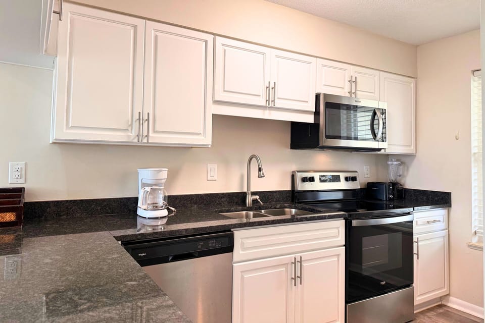 Your fully equipped kitchen features modern appliances, granite countertops, and plenty of cabinet space—perfect for preparing meals during your stay.