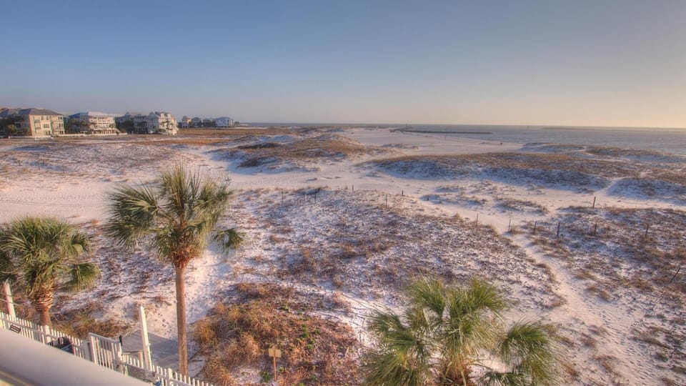 Peaceful East Pass views with sugar-white dunes and coastal grasses—watch boats glide by and enjoy stunning sunsets just moments away.