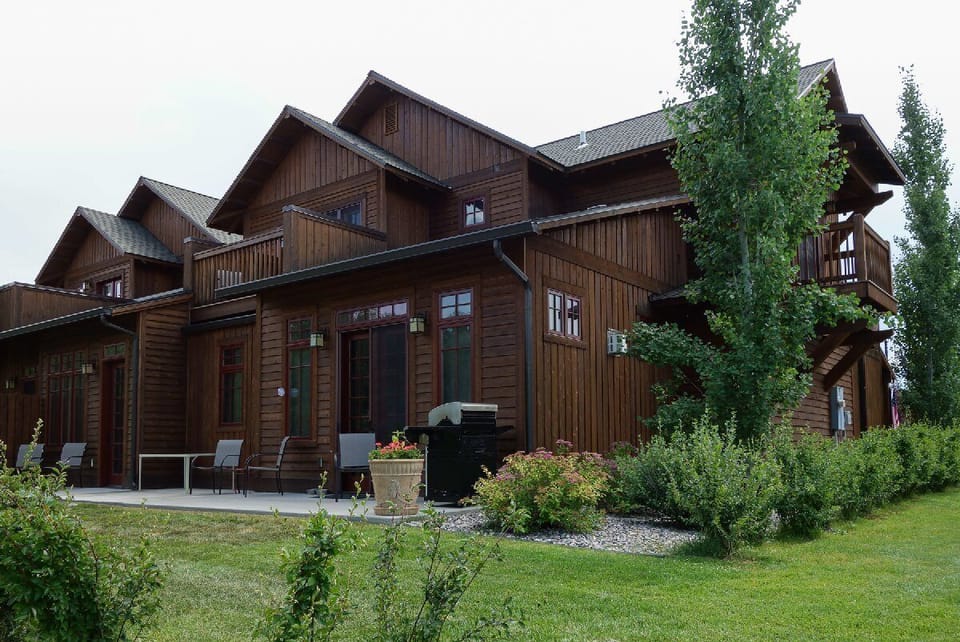 Rear patio with seating and access to walking trail.