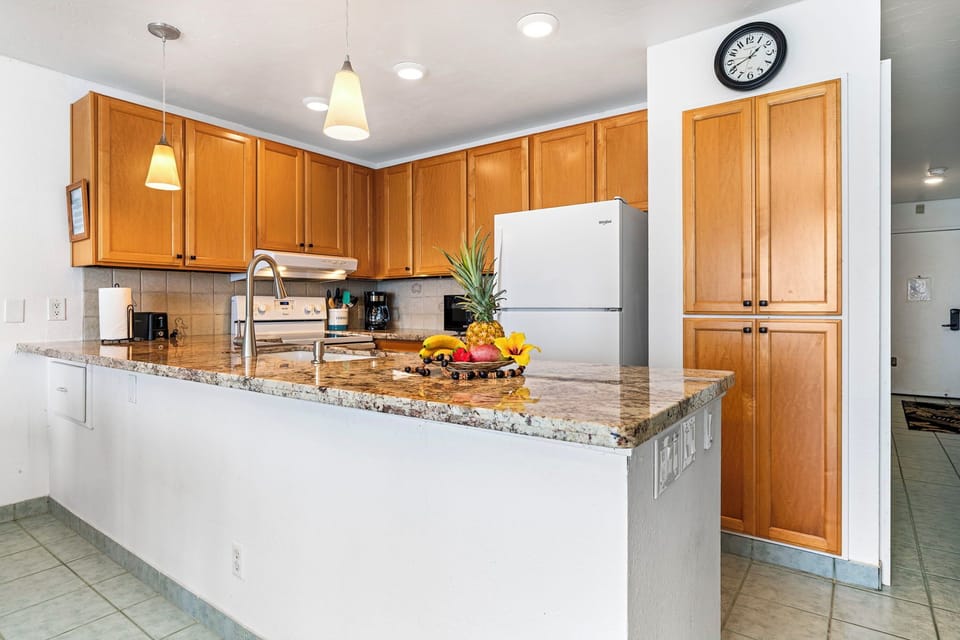 The kitchen contains granite countertops, modern appliances, and is fully stocked for your culinary needs
