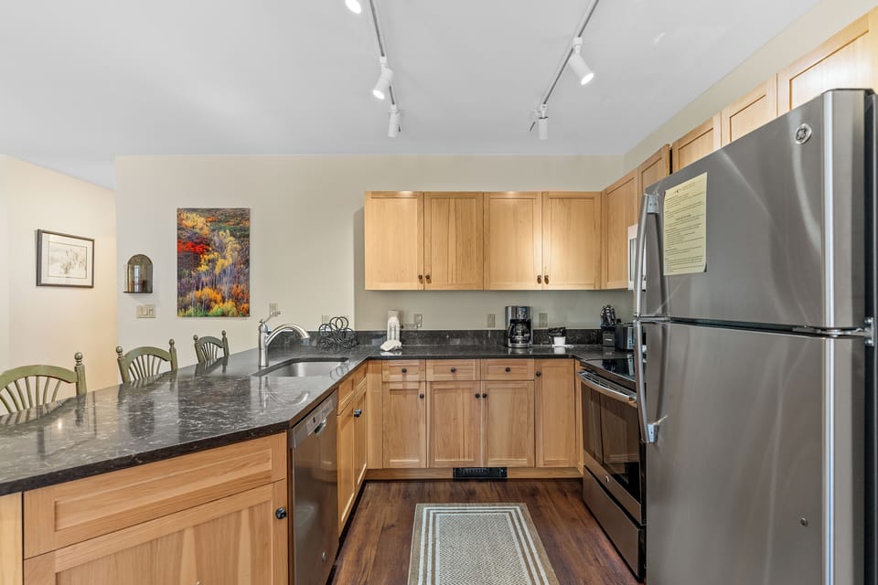 Cook memorable meals in your fully equipped kitchen with granite counters, stainless appliances, and warm wood cabinetry creating the perfect culinary space.
