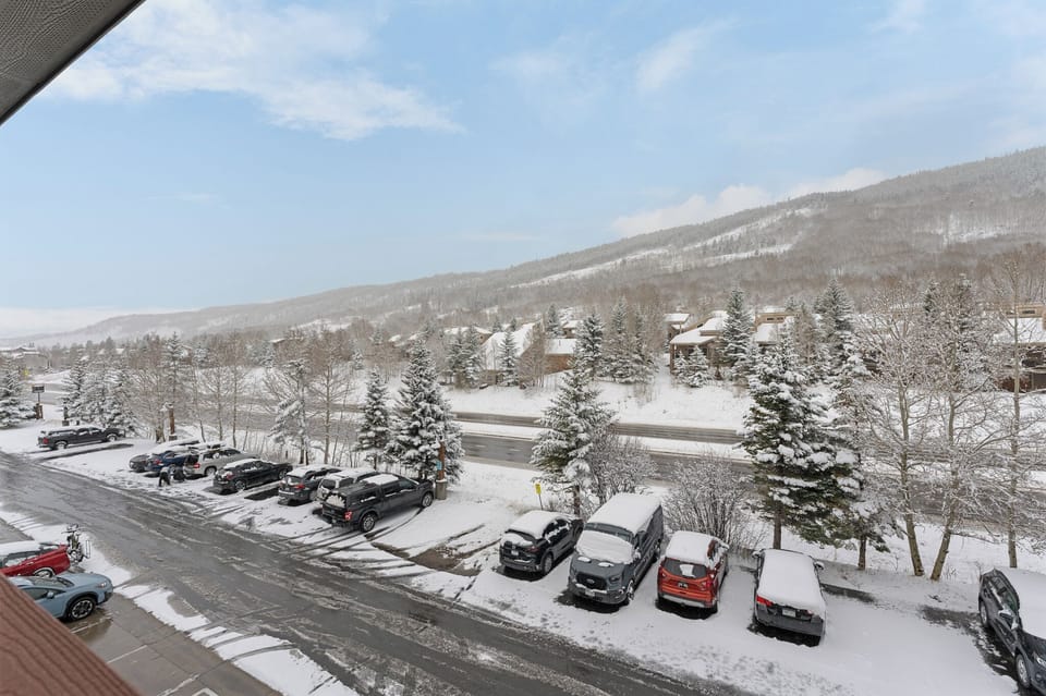 This mountain retreat offers stunning winter scenery with snow-dusted evergreens and hillside views. Convenient parking ensures easy access to nearby slopes and village amenities.