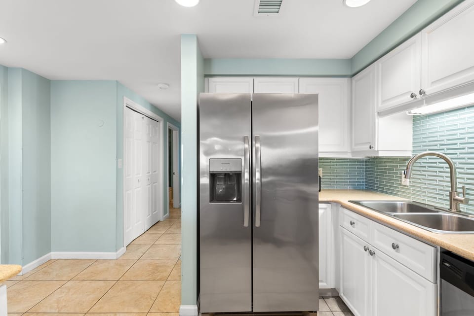 Your fully equipped kitchen features stainless steel appliances and a beautiful glass tile backsplash, perfect for preparing meals during your stay.