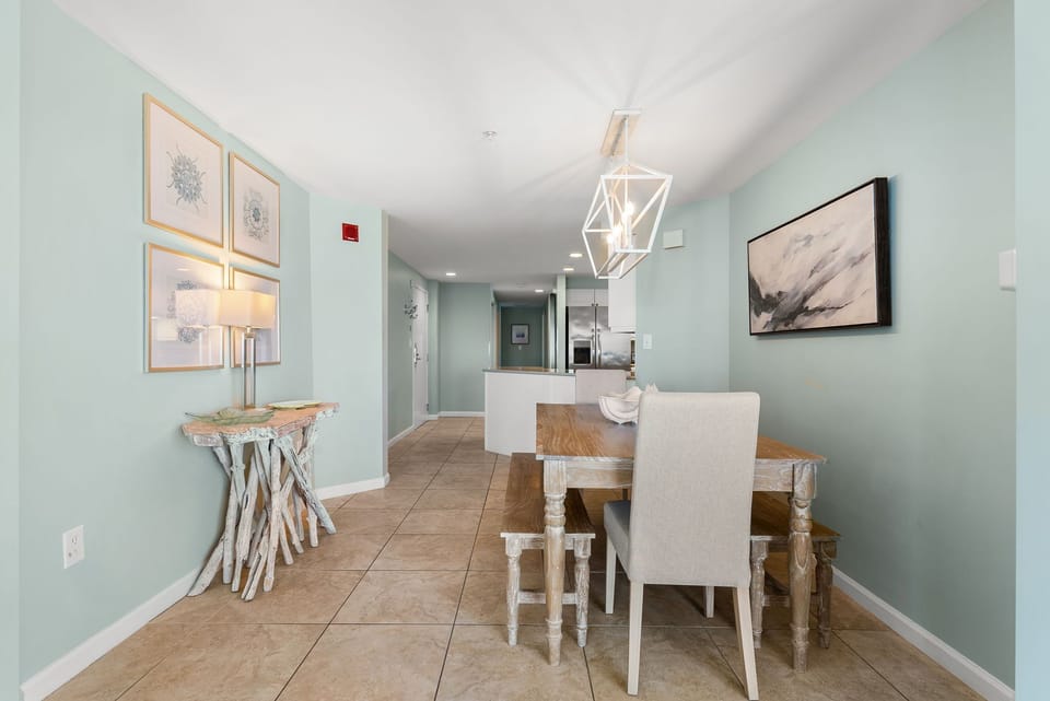 Your elegant dining space features a stunning geometric chandelier above a rustic wood table, perfect for memorable meals together.