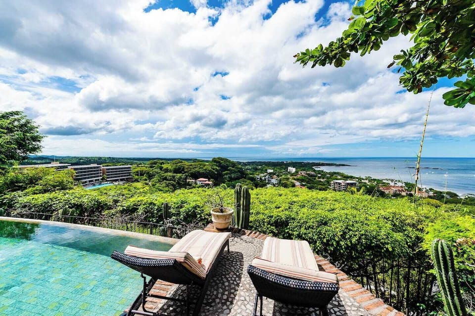 Relax and soak up the sun by the private pool in Tamarindo, perfect for enjoying stunning views and creating unforgettable moments during your vacation rental stay.