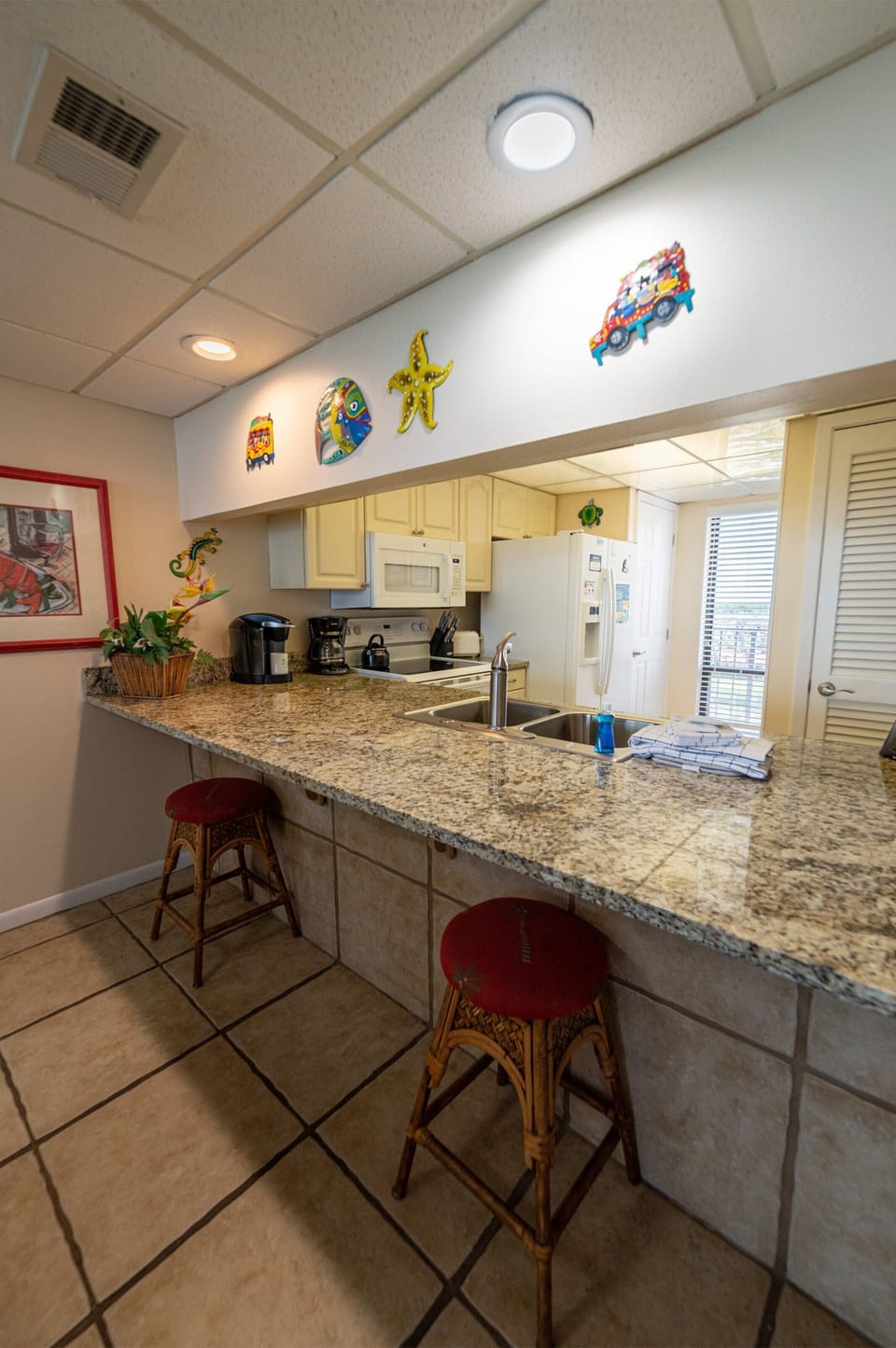See the beach from the kitchen.  The washer dryer is located in the kitchen.