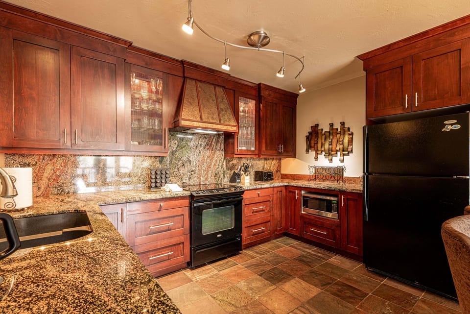 Fully equipped kitchen with rich wood finishes