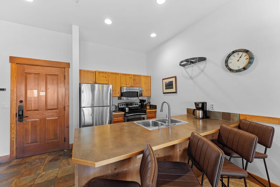 Your fully equipped kitchen awaits with modern appliances and a cozy breakfast bar where you can enjoy morning coffee.