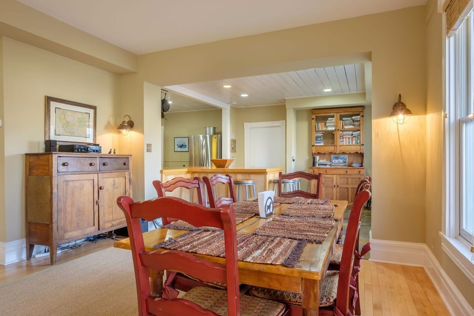 The dining area is open to the kitchen and living room. The table sits six and there are four more stools at the counter.
