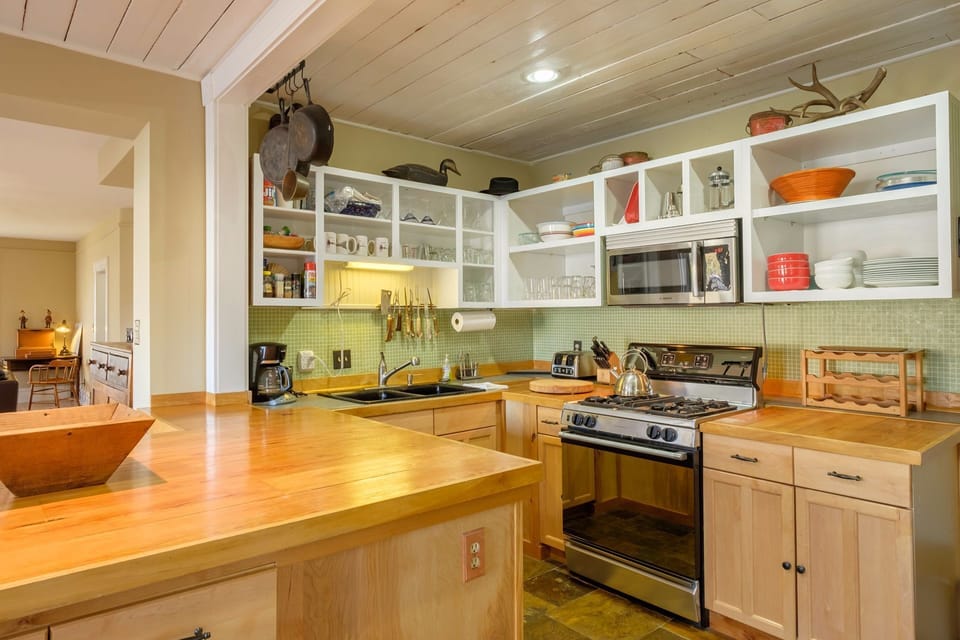 This fully equipped kitchen, with new appliances, has everything you need for a fabulous meals. There's a gourmet range, dishwasher, blender, coffee-maker, garbage disposal and microwave. You will find a selection of cookware, serving ware, even a spice cabinet.
