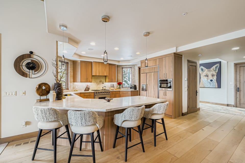 Your fully equipped gourmet kitchen features modern appliances, spacious countertops, and a large island perfect for cooking and casual dining together.
