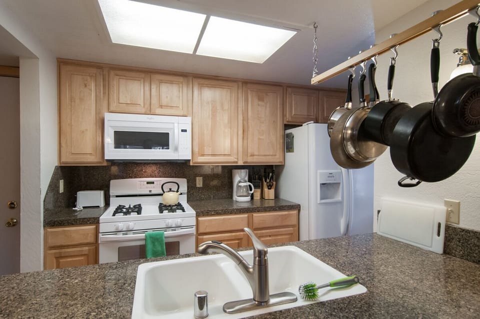 Kitchen sink and breakfast bar makes serving meals and clean up super easy