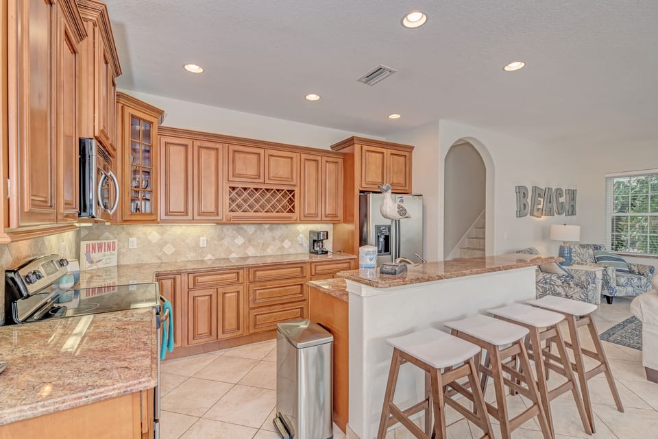Light brown kitchen with island and stools