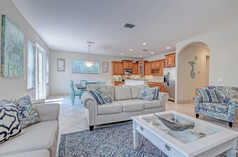 Plush couches showing how close the kitchen and dining are to the living room