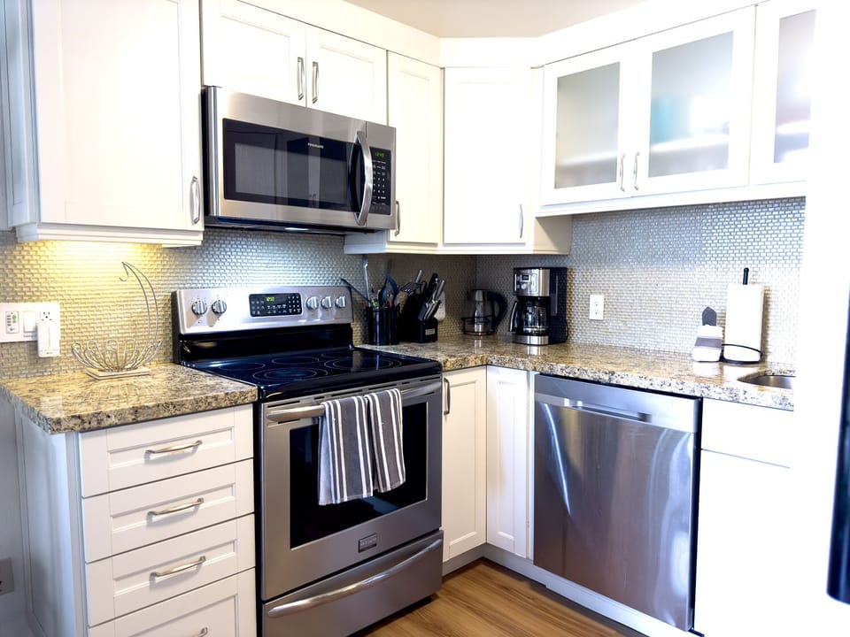 Beautiful and fully remodeled kitchen with granite counters, stainless steel appliances, and gorgeous touches.  Fully stocked for all your food preparation needs.