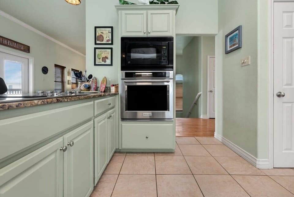 Kitchen with KitchenAid wall oven, microwave, and granite counters