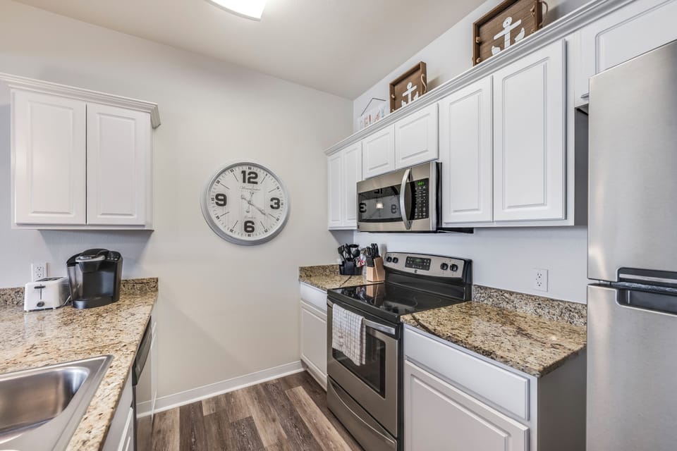 Your fully equipped kitchen awaits with granite counters, stainless appliances, and everything you need to create memorable meals together.