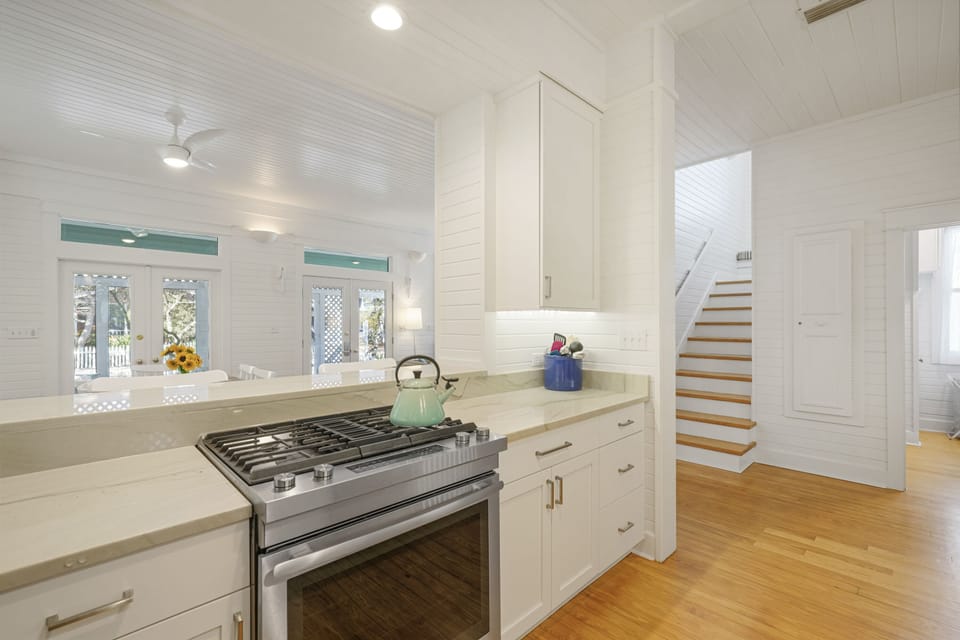 KITCHEN FACING STAIRCASE LEADING TO SECOND LEVEL