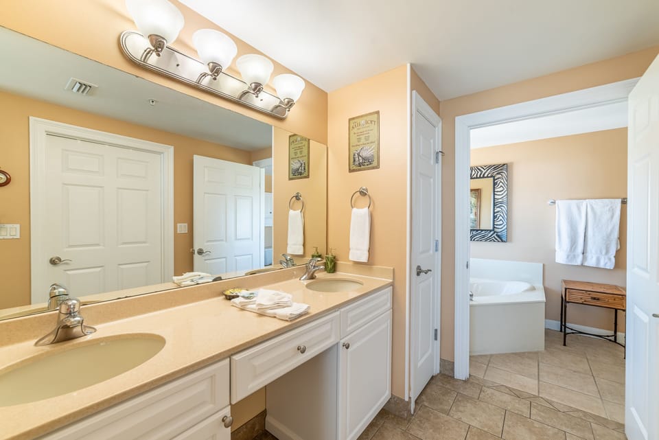 The Main Suite master bath has a separate dressing area with double vanity and a huge walk in closet.