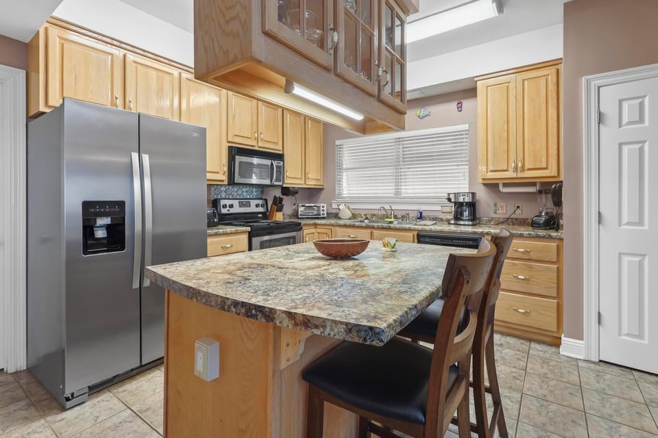Kitchen - The open kitchen features an island that is useful for meal prep, and also offers seating for 2.