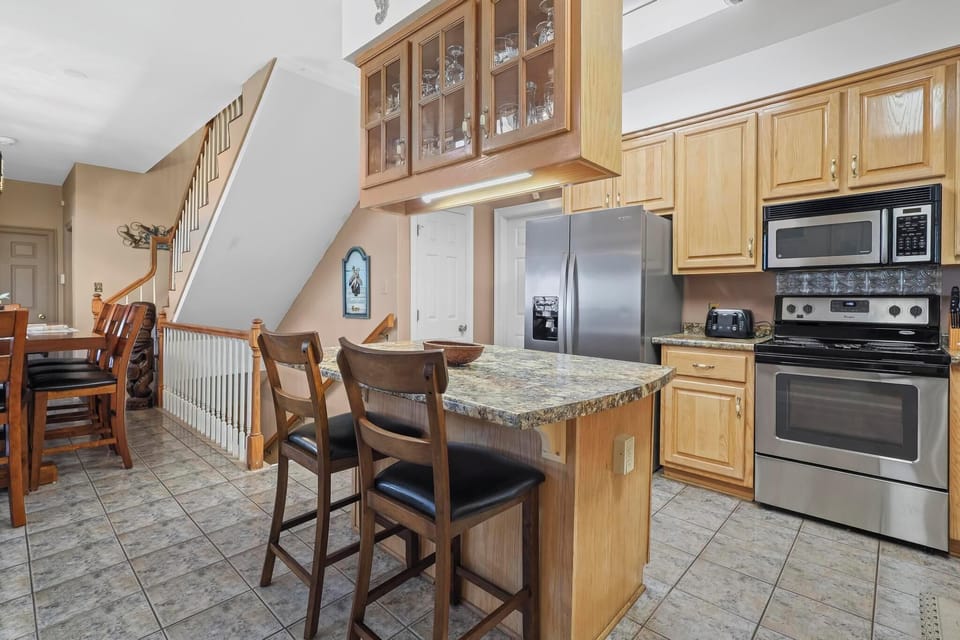 Kitchen - The spacious kitchen features stainless appliances, custom cabinetry, and is fully stocked with all items needed for meal prepping during your stay.