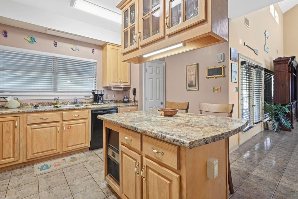 Kitchen - The spacious kitchen features an island that offers plenty of cabinetry, an ice maker, and seating for 2.