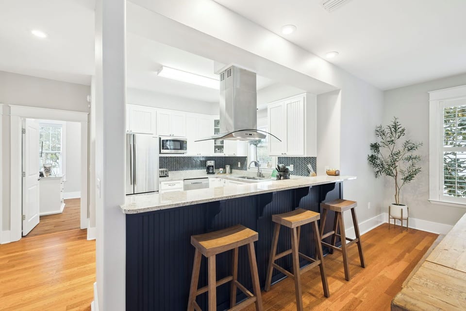 Your modern kitchen awaits with sleek countertops, stainless appliances, and a spacious island perfect for morning coffee or evening meals together.